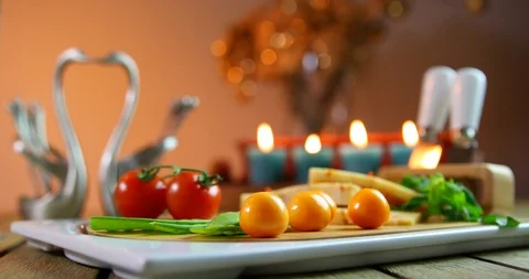 Womans hand put the fork into cheese . yellow cheese with fresh vegetables Video stock 91882588
