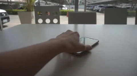 Woman's hand put the phone on the table slow motion scene HD Stockbeeldmateriaal 65832502