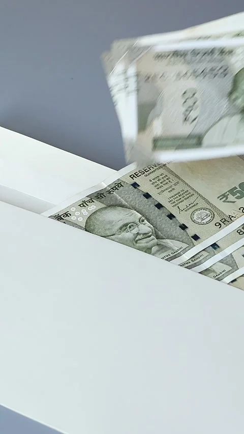 Woman's hand put several banknotes of Indian rupees into the envelope Video stock 306082033