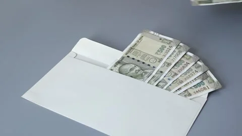 Woman's hand put several banknotes of Indian rupees into the envelope Video stock 306082316