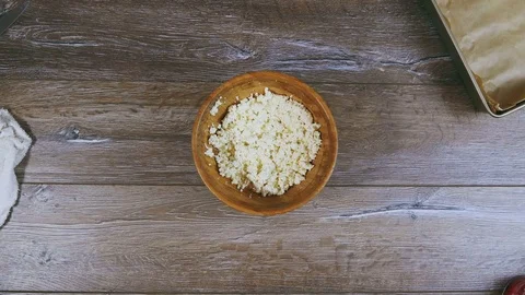 Woman's hand puts a baking sheet close to curd Stock Footage 72987790
