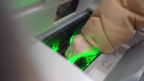 A woman's hand puts banknotes in an atm to replenish the account. Stock Footage 169687810