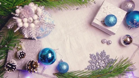 Woman's hand puts a Christmas wrapped gift on a decorated table with flashing Video stock 82466025
