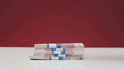A woman's hand puts the euro on the table Stock Footage 185944563