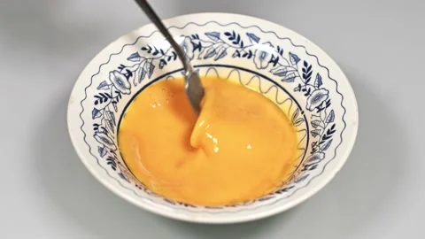 Woman's hand puts a piece of bread in whipped egg and impregnates it Stock Footage 151329273