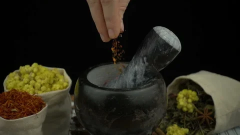 Woman's hand puts red pepper into the granite mortar with pestle in slow motion. Stock Footage 132667198