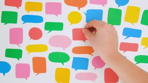 A woman's hand puts a red speech bubble Stock Footage 301864854