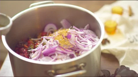 Woman's hand putting spice into the pan with chopped onions Stock Footage 76140328