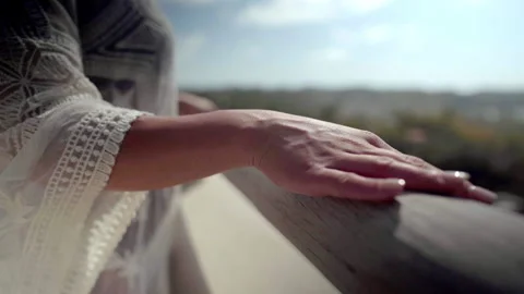 Woman's hand on railing of balcony Stock Footage 138602996