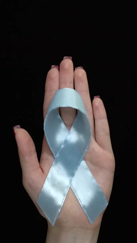 Woman's hand with red nails holding a light blue satin ribbon on black backgroun Stock Footage 345138745