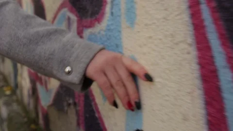 Woman's hand with red nails touching concrete wall Stock-Footage 70156531