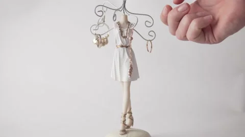 A woman's hand removes rings and earrings from a beautiful jewelry stand, a Stock Footage 161970212