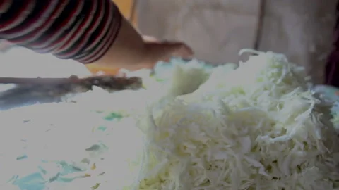 A woman's hand removes a shredded cabbage aside Vídeos de archivo 142802171