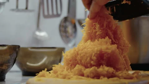 Woman's hand removing grater from kitchen table after grinding pie pumpkin Stock Footage 337120958