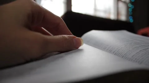 Woman's hand resting on a book Stock Footage 44448109