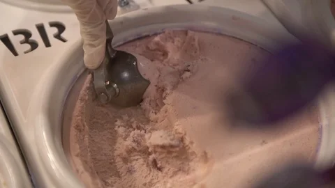 Woman's Hand with scoop make Baskin Robbins ice cream ball Stock Footage 128268368