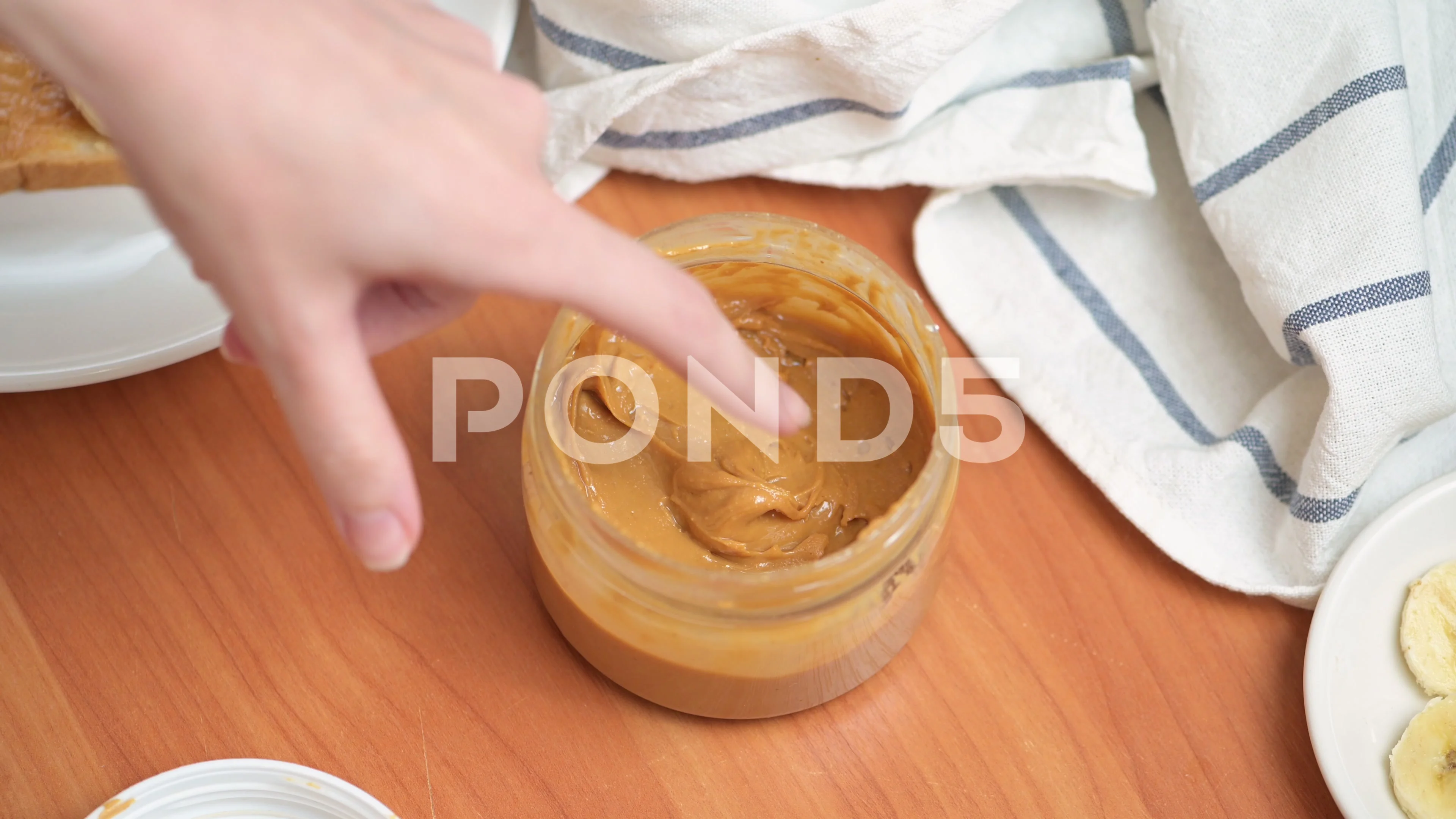 https://images.pond5.com/womans-hand-scoops-peanut-butter-143634581_prevstill.jpeg