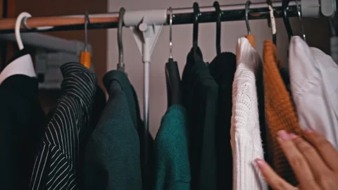 Woman's Hand Selects Things on a Hanger Close-up Stock Footage 254661652