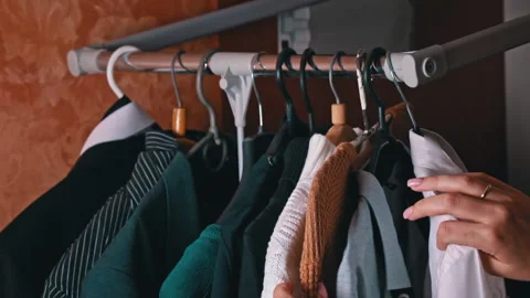 Woman's Hand Selects Things on a Hanger Close-up Stock Footage 255392094