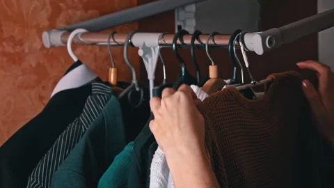 Woman's Hand Selects Things on a Hanger Close-up Stock Footage 255516224