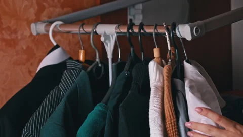 Woman's Hand Selects Things on a Hanger Close-up Stock Footage 255580803