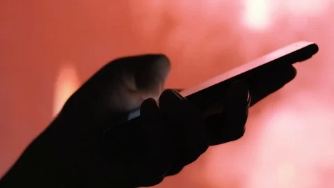 Woman's hand sending a message on a mobile phone with fireworks in background Stock Footage 92200815