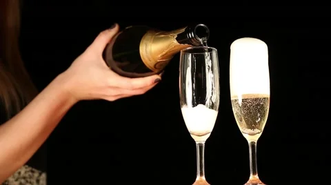A woman's hand serving champagne into glasses close up clip Stock Footage 44931816