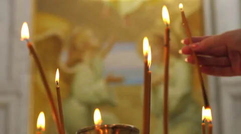 Woman's hand sets a candle into a candlestick. Video stock 51416699