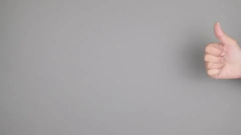 Woman's hand showing gesture class on grey  background Stock-Footage 132874021