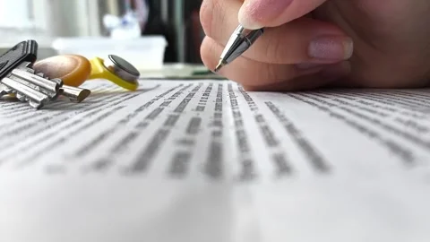 A womans hand signs documents on the purchase or sale of an apartment or house Stock Footage 314880012