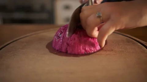 Woman's hand slice red fruit with knife Stock Footage 167754136