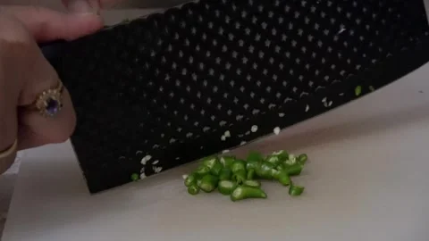 Woman's Hand Slicing Chili Angle 1 Stock Footage 308809198