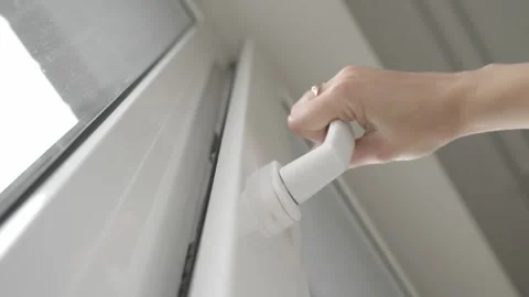 A woman's hand slightly opens a PVC window to ventilate and let in fresh air. Video stock 255117810