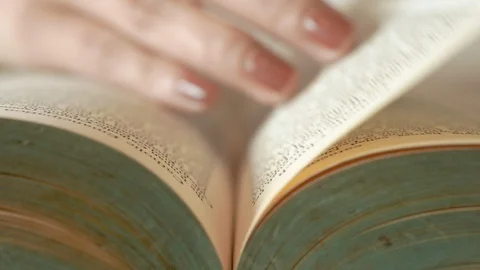 The woman's hand slowly opens the old book. Stock Footage 115130330