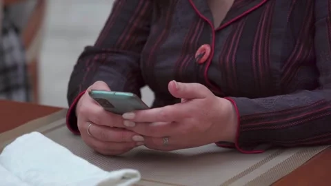 Womans hand with smartphone on table, close-up, everyday moment Stock Footage 294629147