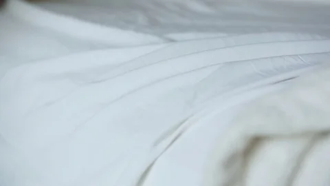 Woman's Hand Smoothing Over A White Bed Sheet Stockbeeldmateriaal 76132838
