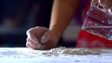 A woman's hand spills flour on the table. Video stock 104641397