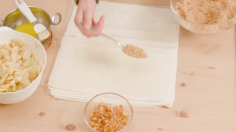 Woman's hand spreading breadcrumbs and sugar at pie crust shot from above Video stock 121296610