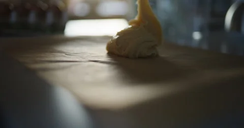 Woman's Hand Spreading Dough on Baking Paper Stock Footage 308419297