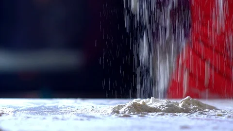 Woman's hand sprinkles flour on the table. Stock Footage 104641118