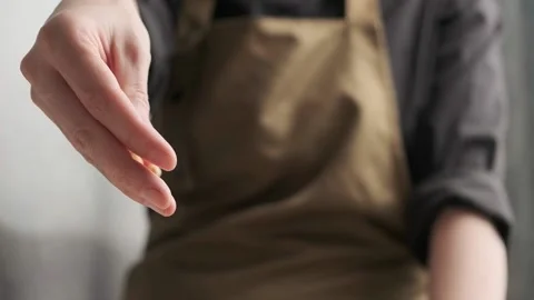 Woman's hand sprinkles pine nuts salad. Close-up in slow motion, Stock Footage 159337761