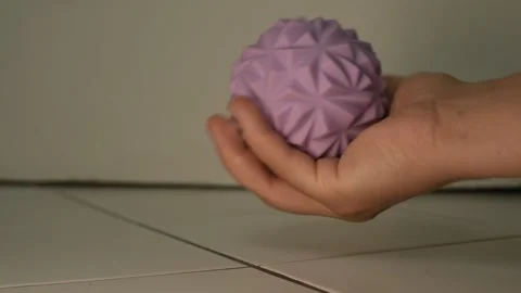 Womans Hand Squeezing a Hard Purple Massage Ball Stock-Footage 314602263