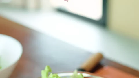 Womans hand squeezing lime for recipe, a gesture in cuisine science 스톡 동영상 271625632