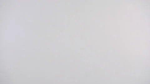 Woman's hand sticking note with a sad face emoticon over a white background Stock Footage 132233307