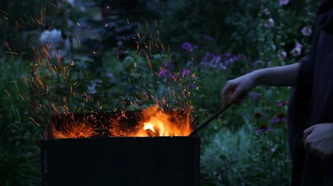 Woman's hand stirring the coals Stock Footage 66420822