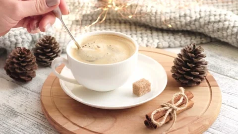Woman's hand stirring sugar cube in cup of coffee with spoon. Close-up, slow Stock Footage 165336814
