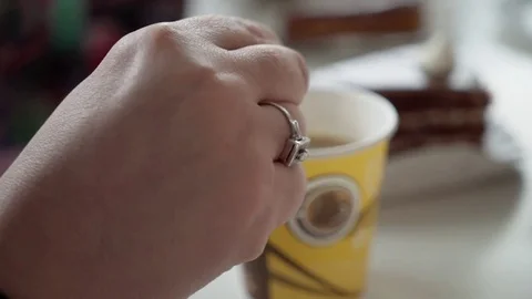 A woman's hand stirs tea close up. A female team sits in a cafe for a cup of tea Stock Footage 83654719