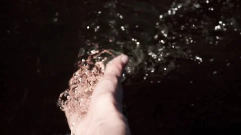 Woman's hand in a stream of water Stock Footage 201602927
