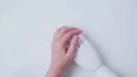A woman's hand strokes the hand of a robot. Artificial intelligence support Stock Footage 201817582