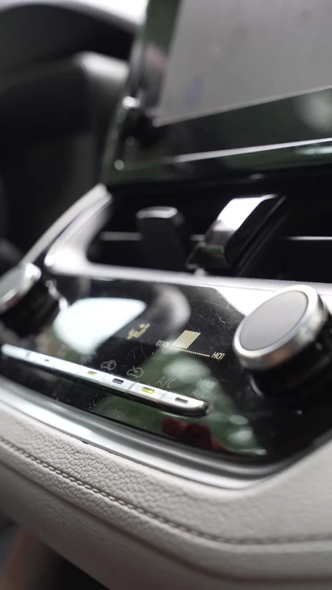 Woman's hand switching the air conditioning in car Stock Footage 345011408
